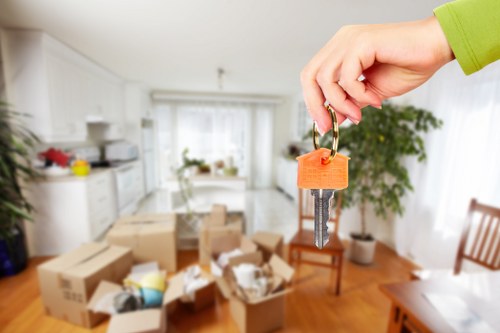 Professional movers handling office equipment